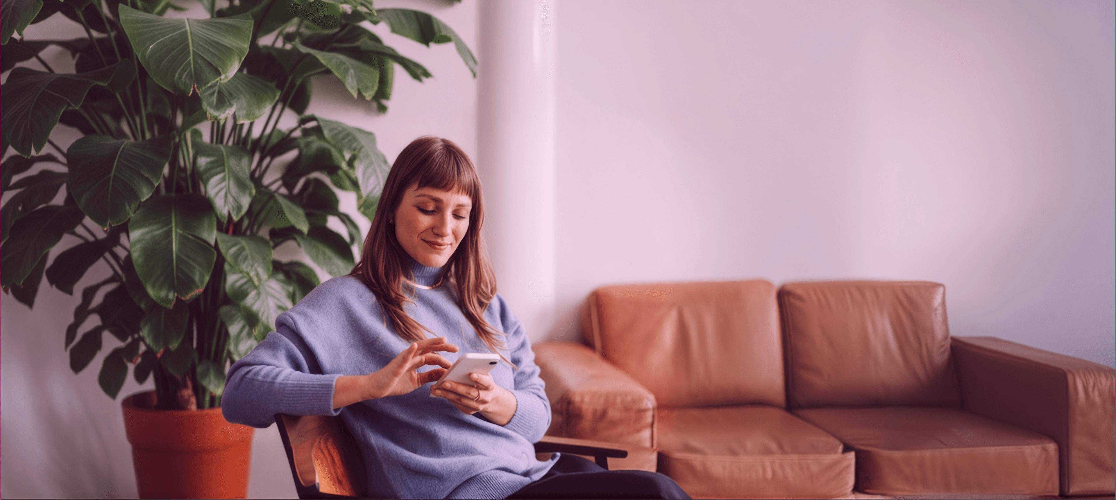Woman on her phone using Ezi Broadband internet at home