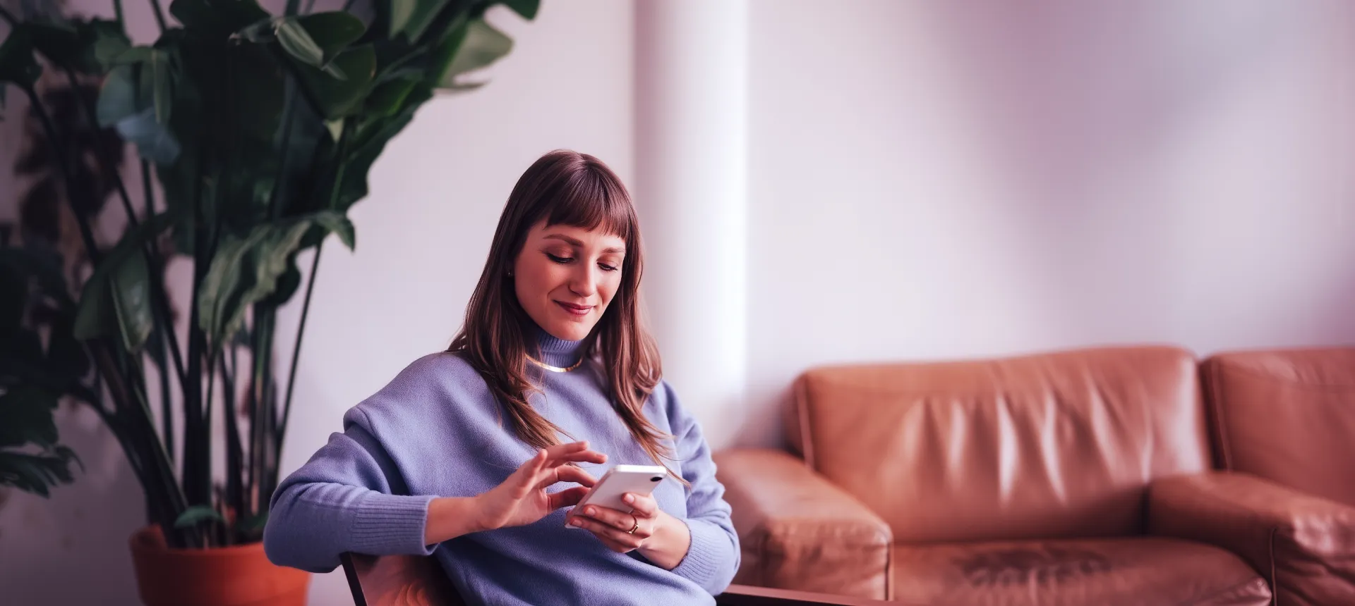 Woman on her phone using Ezi Broadband internet at home